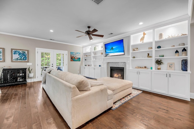 5725 Caviar Ct, Johns Island, SC 29455 - living area with ornamental molding, a ceiling fan, a glass covered fireplace, dark wood-style flooring, and french doors