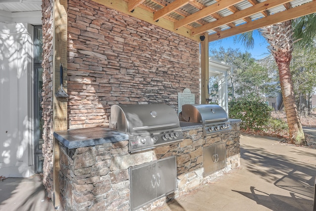 view of patio / terrace with a pergola, a grill, and exterior kitchen