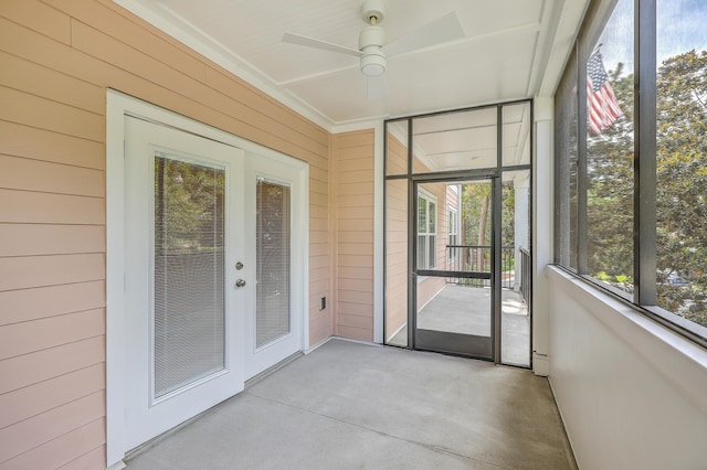 unfurnished sunroom with ceiling fan