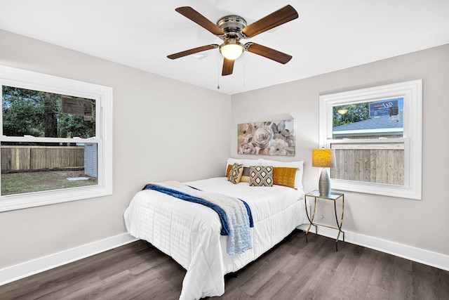 bedroom with dark hardwood / wood-style floors and ceiling fan