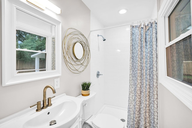 bathroom with sink, toilet, and a shower with shower curtain