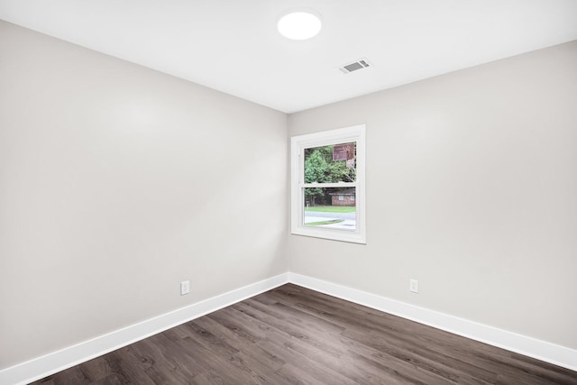 empty room featuring dark hardwood / wood-style flooring