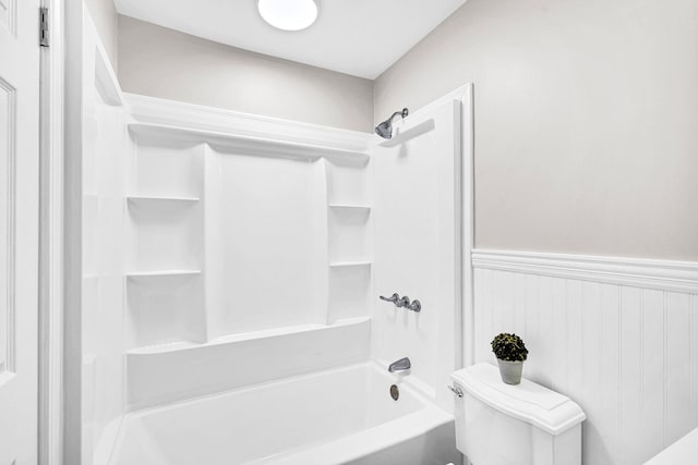 bathroom featuring bathing tub / shower combination and toilet