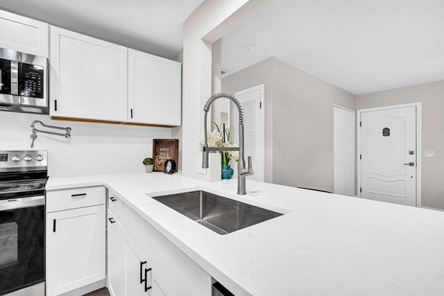 kitchen featuring white cabinetry, sink, and stainless steel appliances