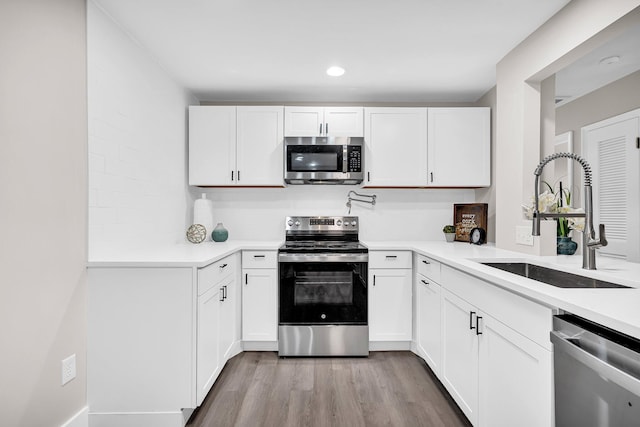 kitchen featuring white cabinetry, appliances with stainless steel finishes, and sink