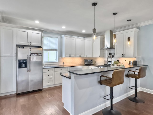 4 Line St, Charleston, SC 29403 - kitchen featuring stainless steel appliances, wall chimney range hood, dark countertops, dark wood-type flooring, and crown molding