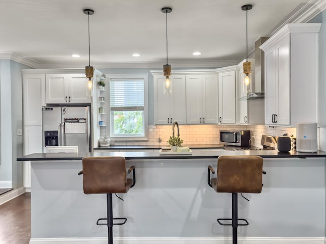 4 Line St, Charleston, SC 29403 - kitchen with stainless steel appliances, dark countertops, decorative backsplash, decorative light fixtures, and crown molding