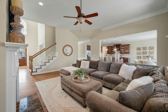 living area featuring dark wood finished floors, recessed lighting, stairway, ornamental molding, and baseboards