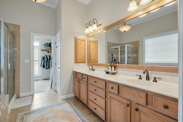 full bath with double vanity, a stall shower, a sink, and tile patterned floors