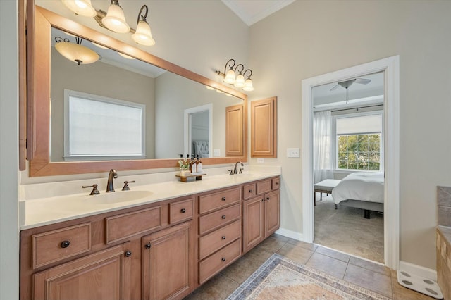 full bathroom featuring double vanity, tile patterned flooring, crown molding, and a sink