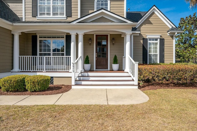 view of exterior entry with a porch