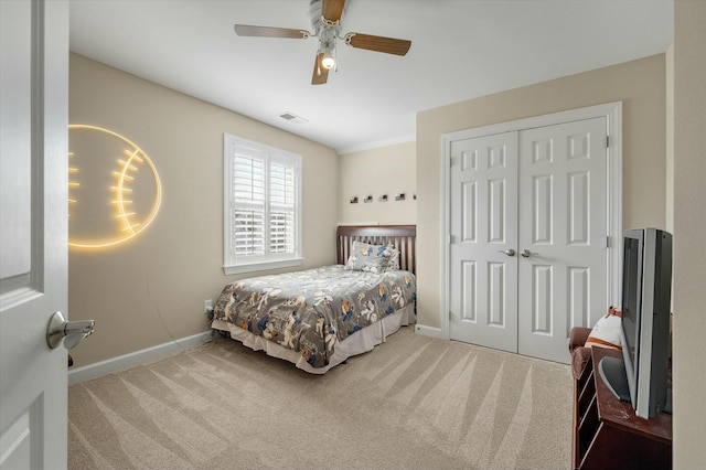 carpeted bedroom with baseboards, visible vents, ceiling fan, and a closet