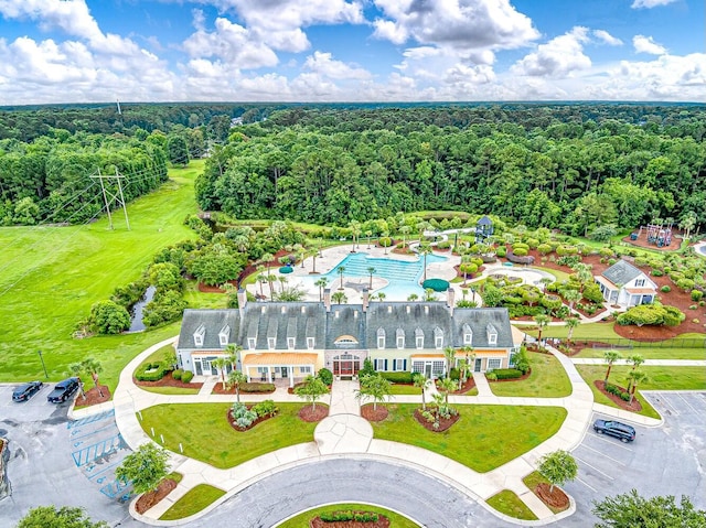 drone / aerial view featuring a wooded view