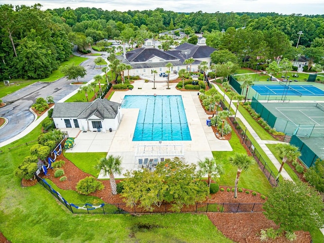 view of pool with fence and a view of trees