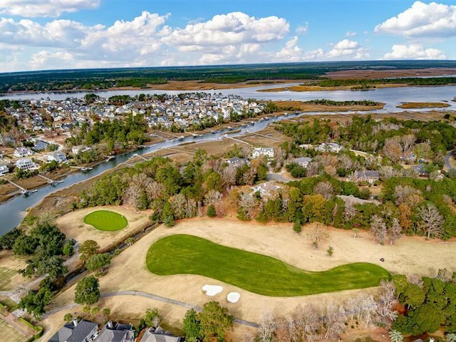 birds eye view of property with a water view and golf course view