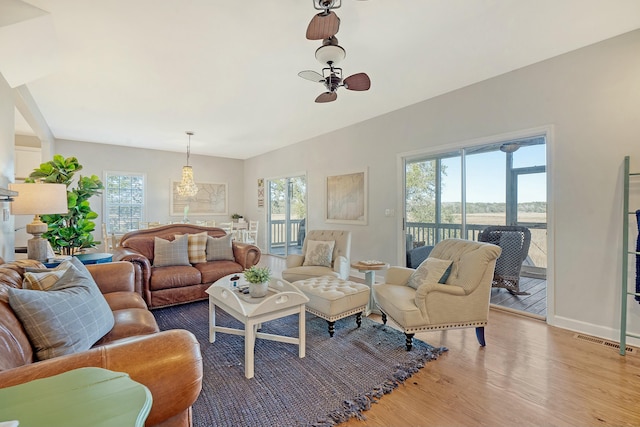 living room featuring a wealth of natural light and light hardwood / wood-style floors