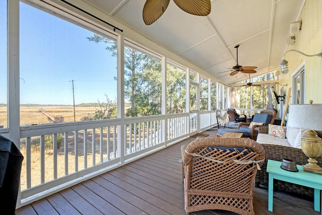 sunroom / solarium with lofted ceiling and ceiling fan