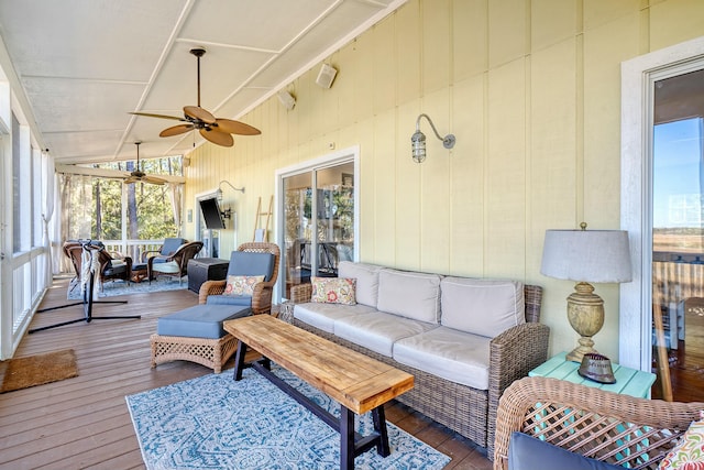 sunroom / solarium with ceiling fan and lofted ceiling