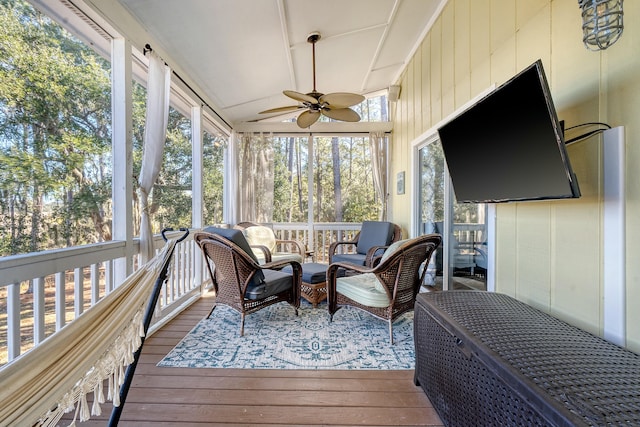 sunroom featuring lofted ceiling and ceiling fan