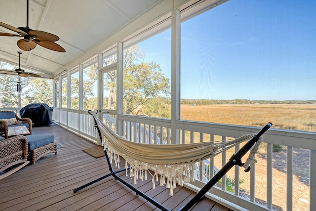 sunroom / solarium with lofted ceiling and a rural view