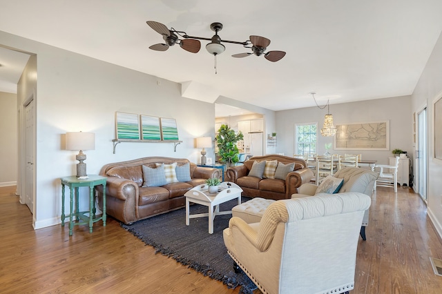 living room featuring hardwood / wood-style floors and ceiling fan