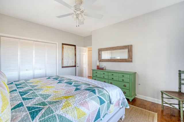 bedroom with dark hardwood / wood-style flooring, a closet, and ceiling fan