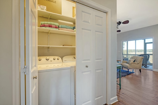 clothes washing area featuring hardwood / wood-style floors and washing machine and clothes dryer