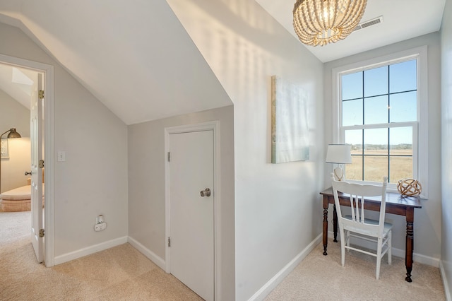 hall with light carpet and vaulted ceiling