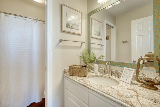 bathroom with walk in shower and vanity