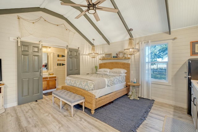 bedroom with vaulted ceiling with beams, wooden walls, a barn door, and light wood-type flooring