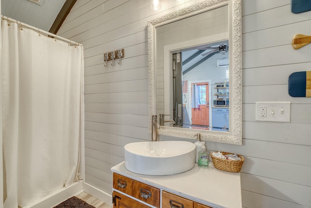 bathroom with vaulted ceiling, vanity, wooden walls, and a shower with shower curtain