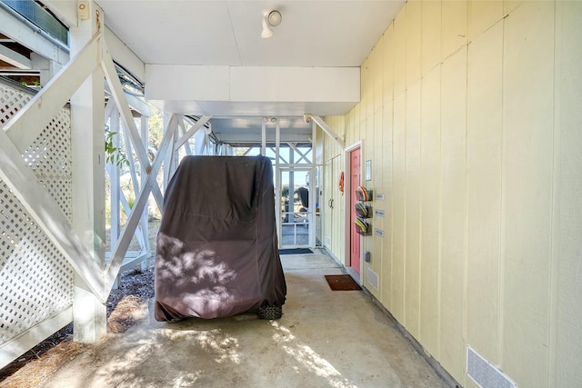 interior space with wooden walls and concrete floors