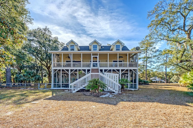 rear view of house with a sunroom, covered porch, and ceiling fan