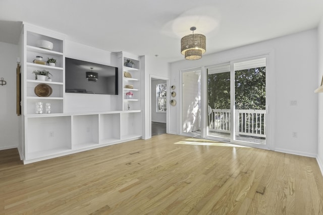 unfurnished living room featuring light wood-style floors and baseboards