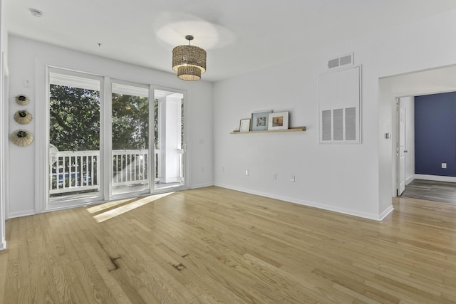 interior space featuring light wood-style flooring, visible vents, and baseboards