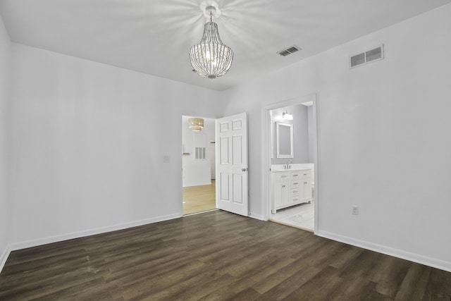 unfurnished bedroom with baseboards, visible vents, and dark wood-style flooring