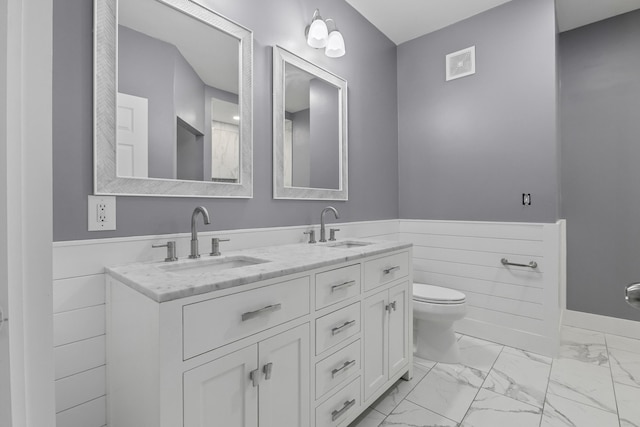 bathroom with marble finish floor, a sink, and visible vents