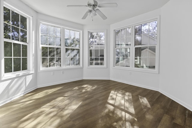 unfurnished sunroom featuring a ceiling fan