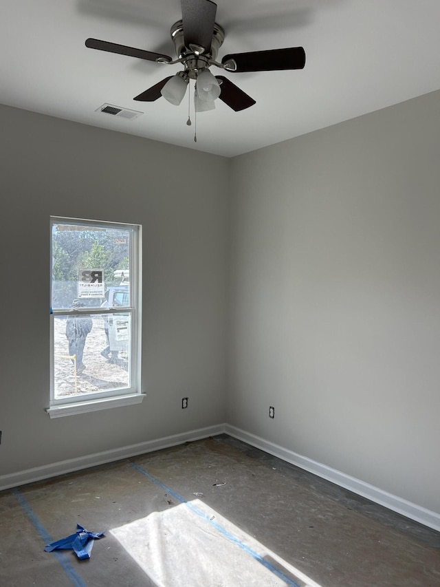 unfurnished room featuring baseboards, visible vents, and ceiling fan