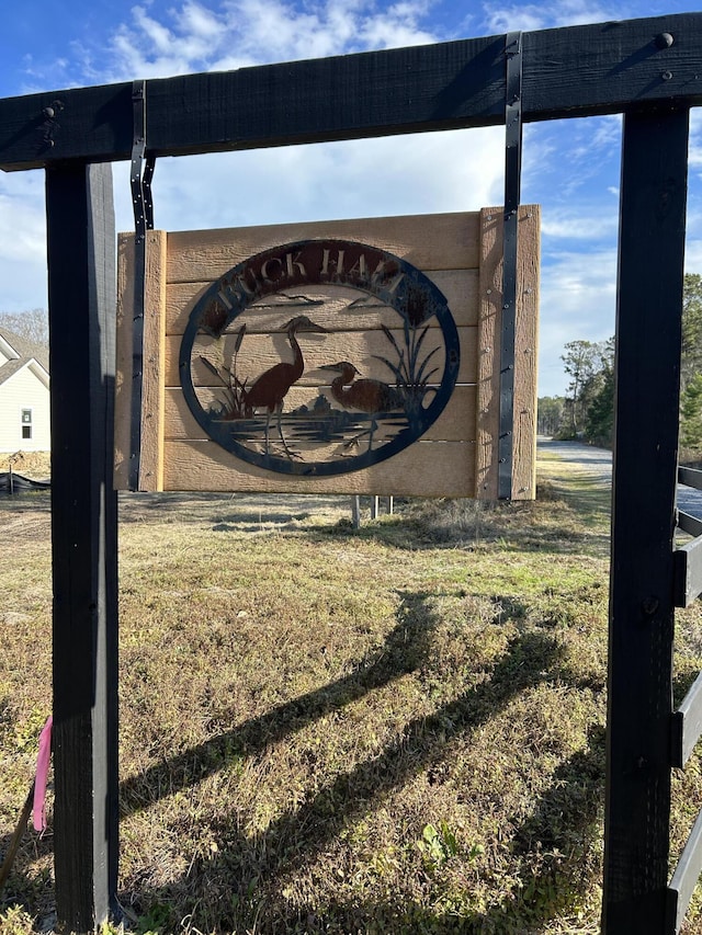 community / neighborhood sign with a yard