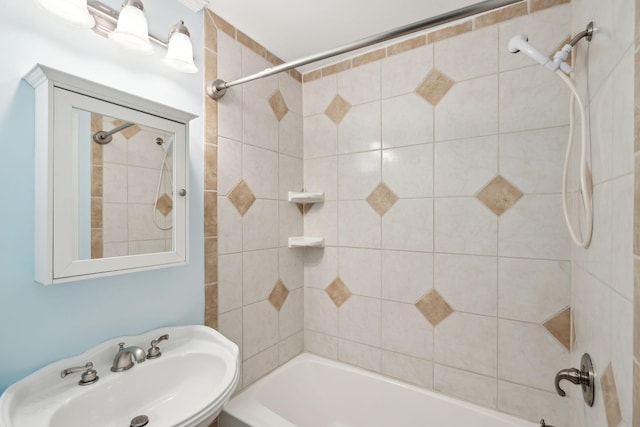 bathroom featuring shower / bath combination and a sink