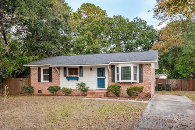 ranch-style home featuring a shingled roof, crawl space, fence, a front lawn, and brick siding