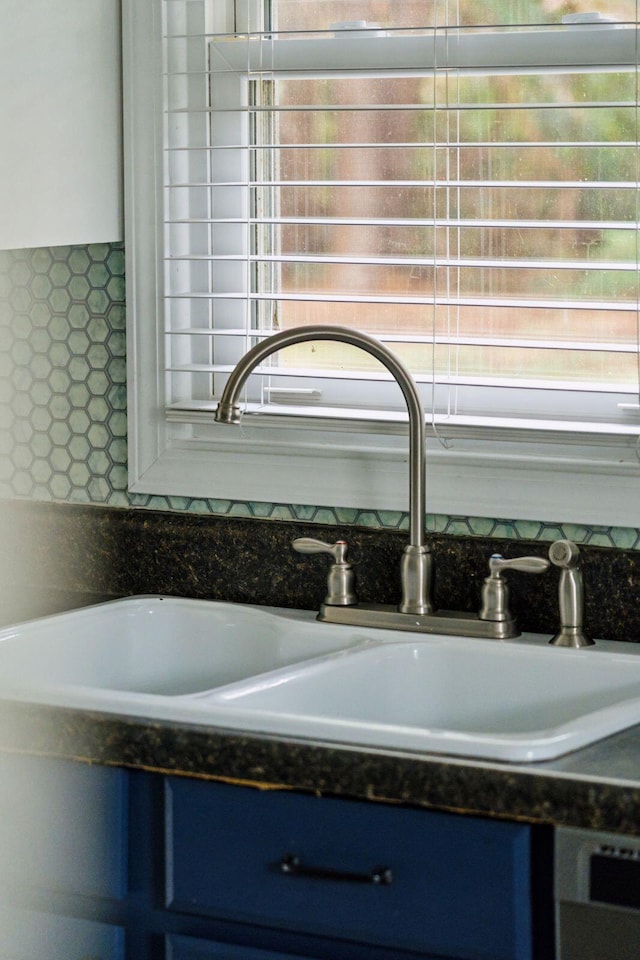 room details featuring blue cabinetry and a sink