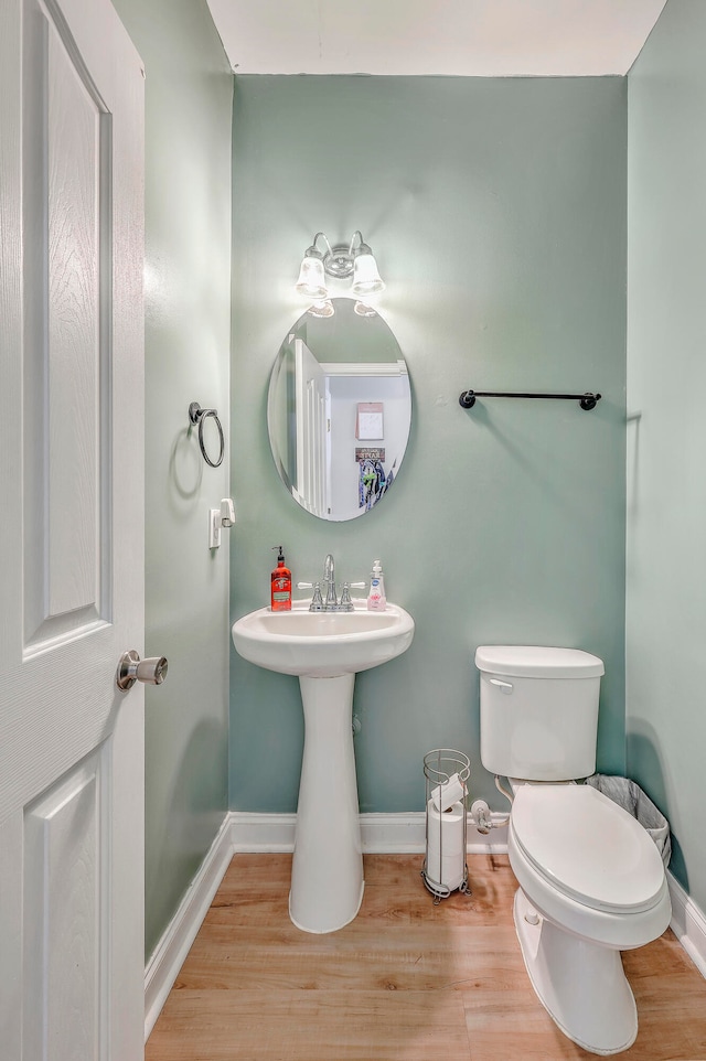 bathroom with wood-type flooring and toilet