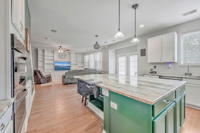 kitchen featuring a center island, white cabinetry, light hardwood / wood-style flooring, green cabinets, and ceiling fan