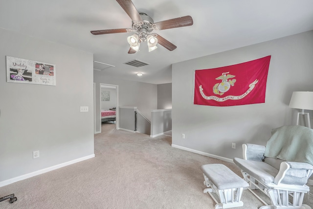 living area featuring ceiling fan and light colored carpet