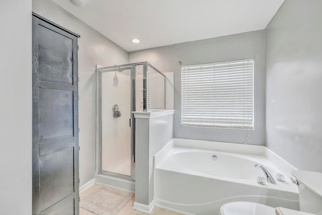 bathroom featuring separate shower and tub