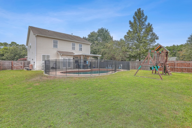 view of yard featuring a fenced in pool and a playground