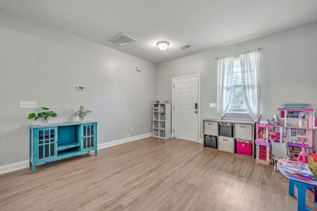 playroom with light wood-type flooring