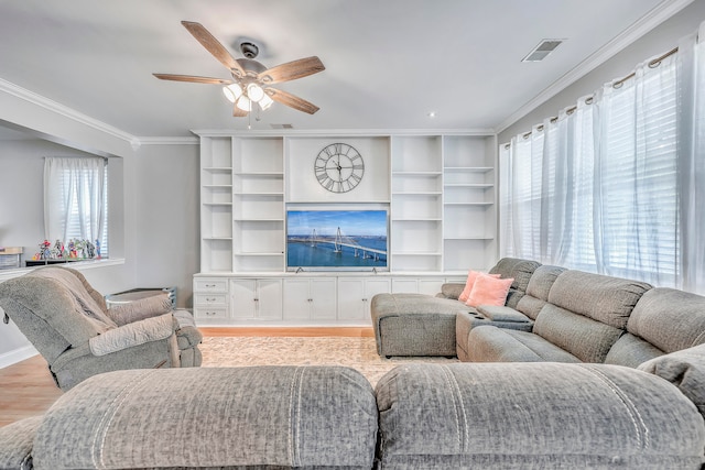 living room with ceiling fan, ornamental molding, and light hardwood / wood-style floors